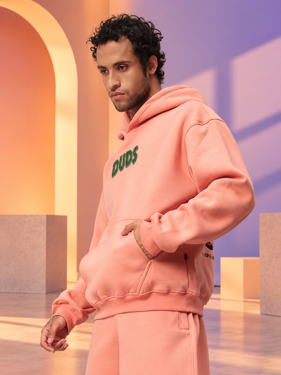 Man wearing JUDY NICK ZOOTOPIA FLEECE CO-ORD PEACH unisex hoodie set, perfect casual streetwear for men and women