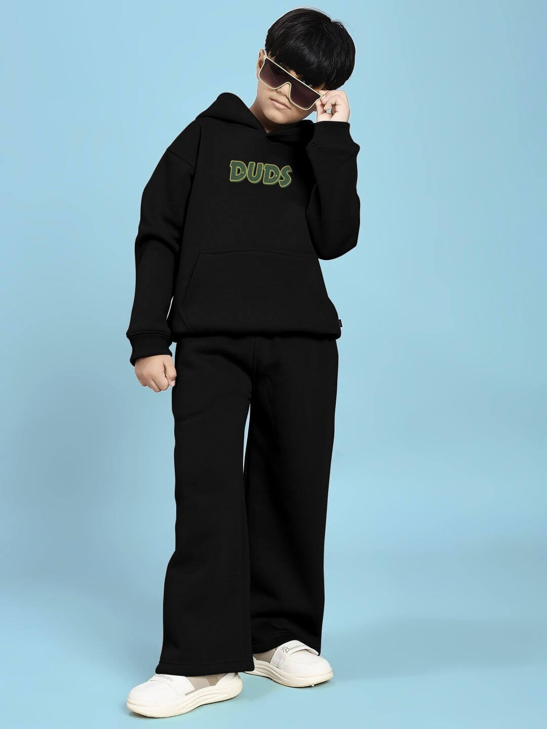 Child wearing JUDY NICK ZOOTOPIA FLEECE CO-ORD FOR BOYS AND GIRLS BLACK with sunglasses for stylish look.