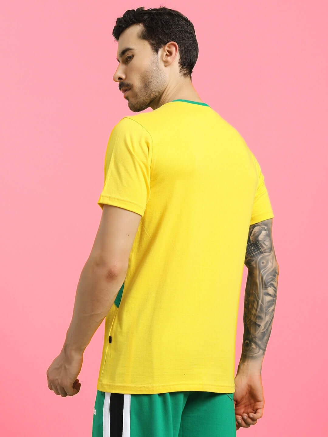 Man wearing JUMPY regular fit yellow T-shirt made of premium 220 GSM 100% cotton, styled with green shorts. Manufactured in India.
