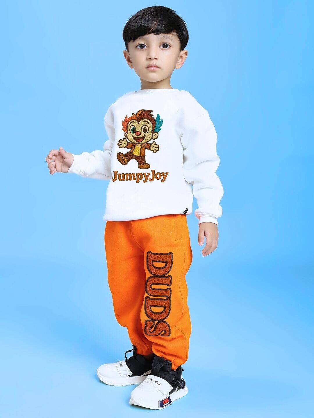 Boy wearing JUMPYJOY CO-ORD FOR BOYS AND GIRLS WHITE ORANGE with playful design and vibrant colors, perfect for trendy kids' outfits.