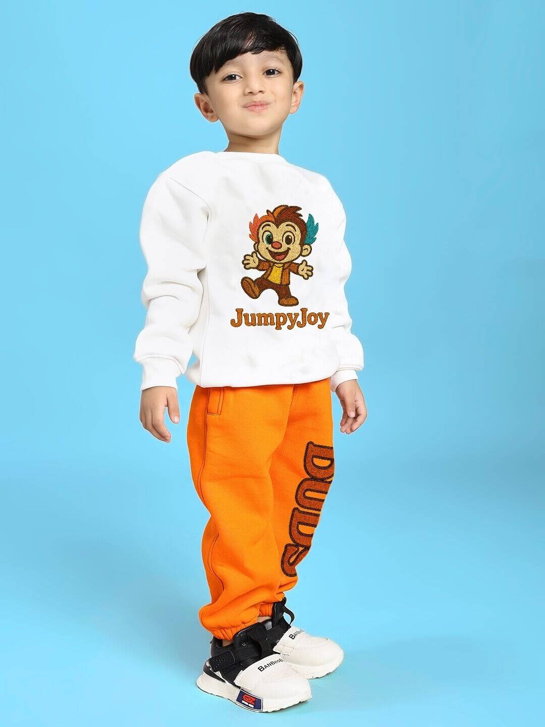 Child wearing JUMPYJOY CO-ORD FOR BOYS AND GIRLS WHITE ORANGE with vibrant colors, showcasing modern fashion and playful design.