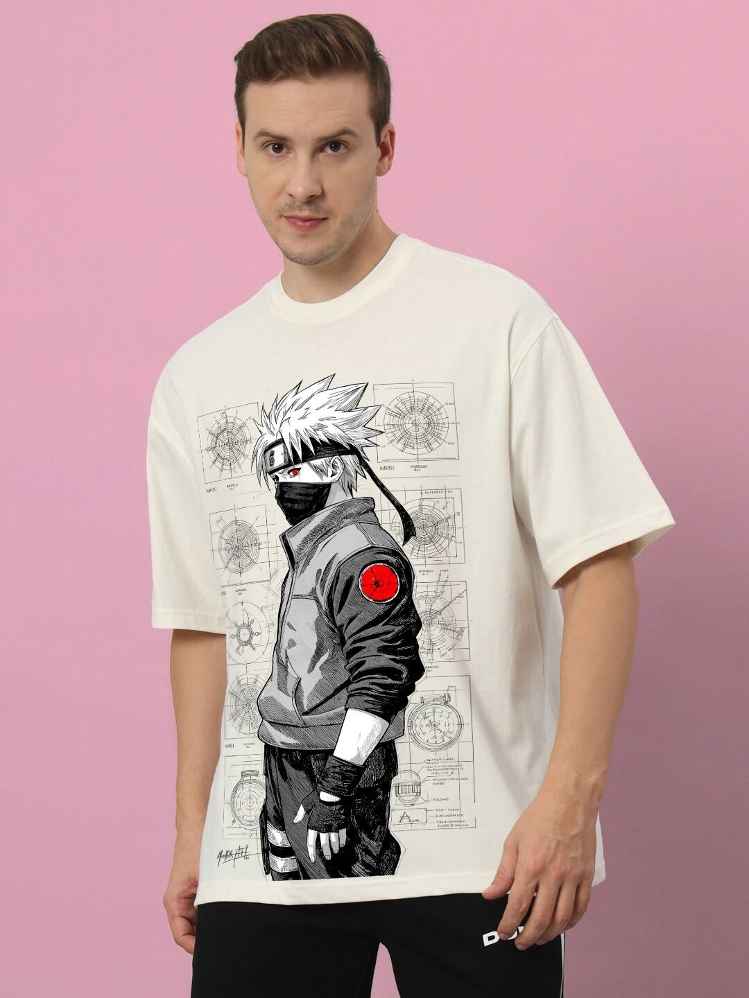 Man wearing KAKASHI PRINTED OVERSIZED T-SHIRT OFF-WHITE against pink background.