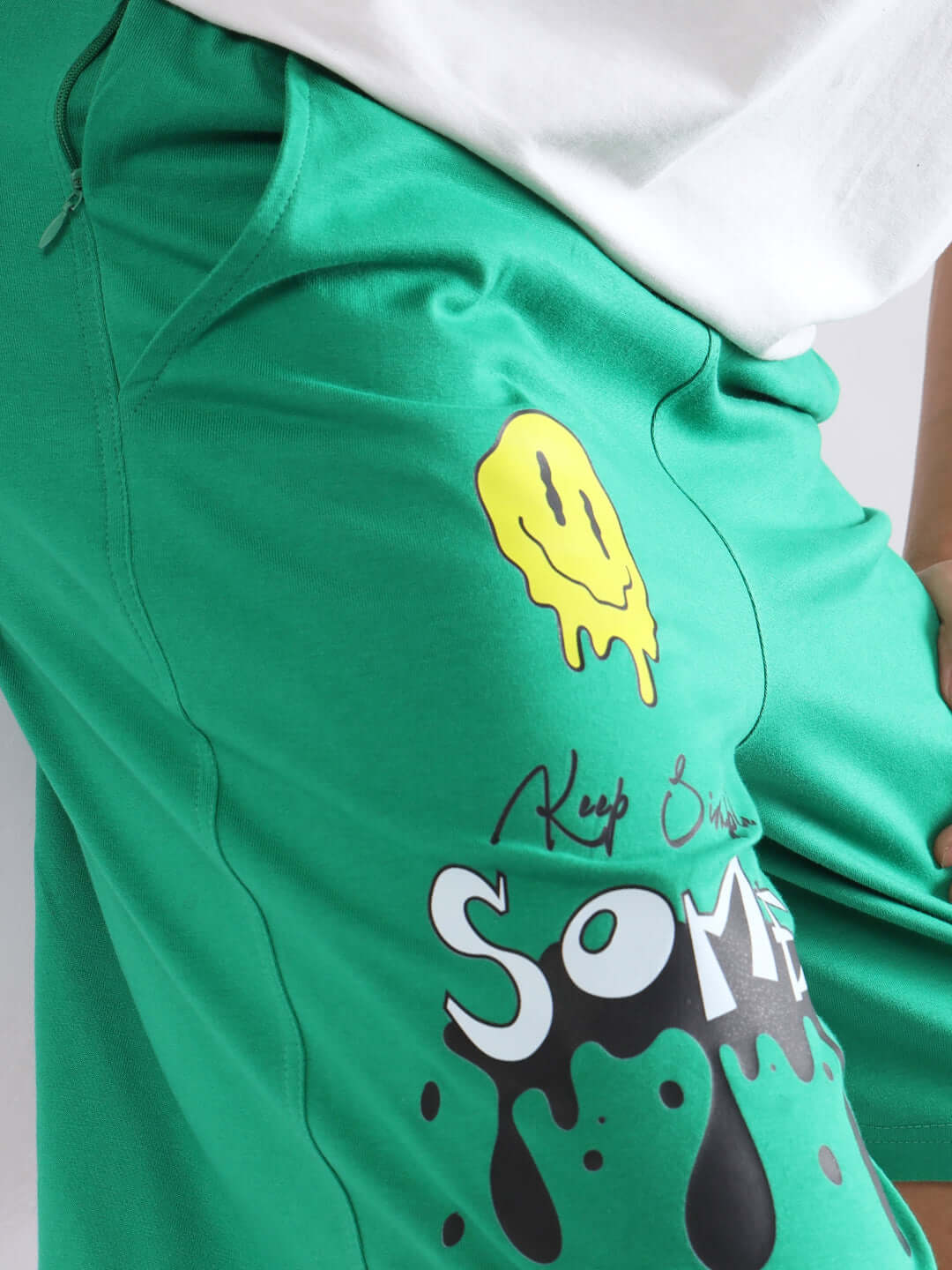 Green KEEP SIMPLE SOME shorts with smiley face design, offering custom size options for personalized fit.