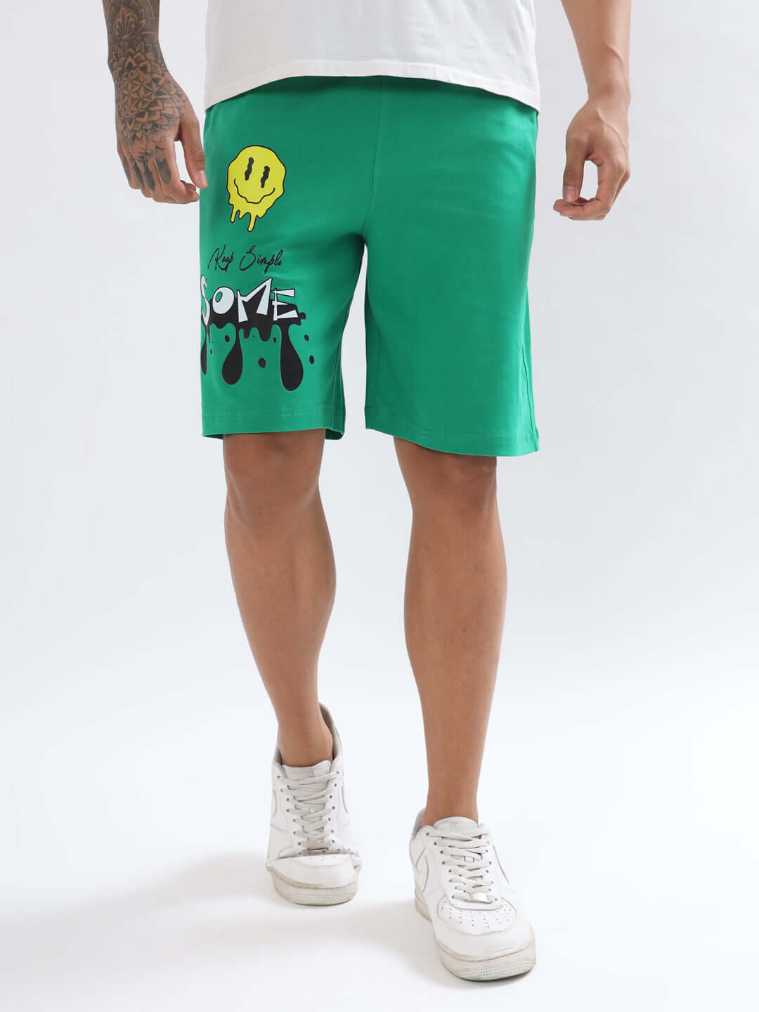 Man wearing KEEP SIMPLE green shorts with smiley design, perfect for comfort and regular fit style. Available in customizable sizes.