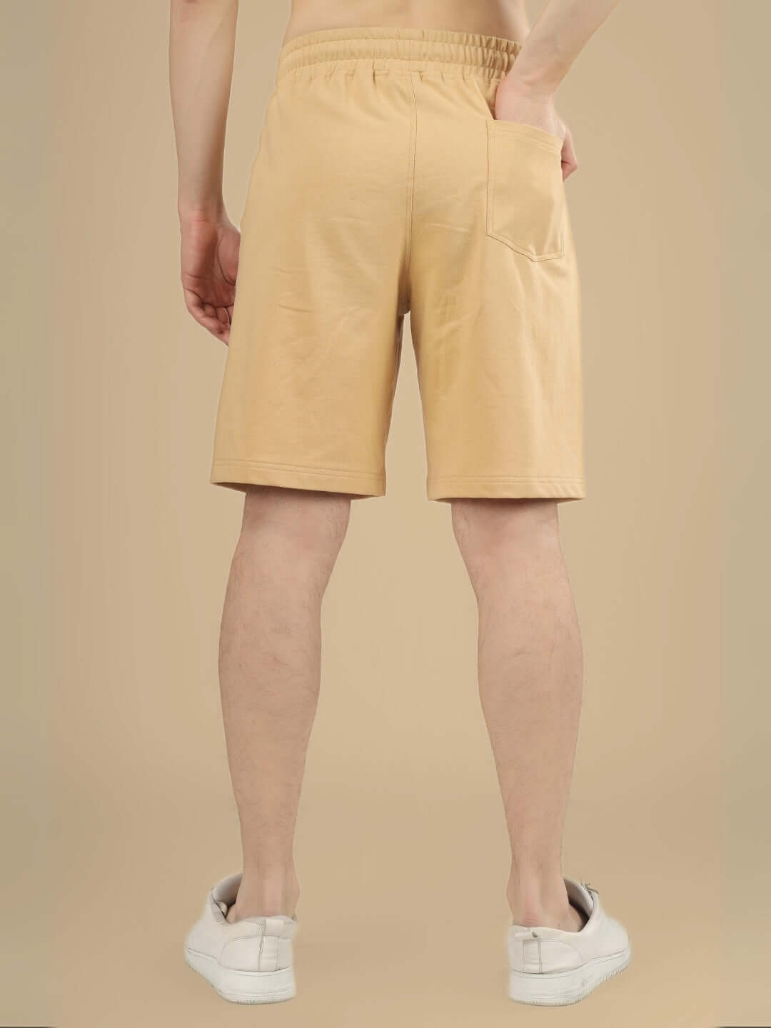 Model wearing KEEP SIMPLE REGULAR FIT Beige Shorts, back view showcasing comfortable fit, ideal for custom-sized prepaid orders.