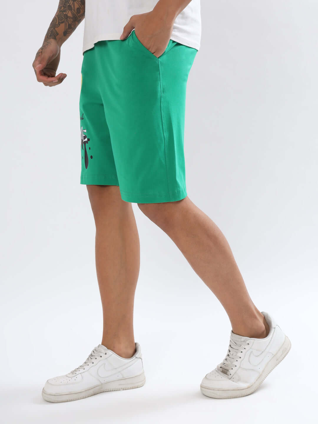 Man wearing green KEEP SIMPLE SOME Regular Fit Shorts with casual white sneakers, available for custom fit orders from DUDS.