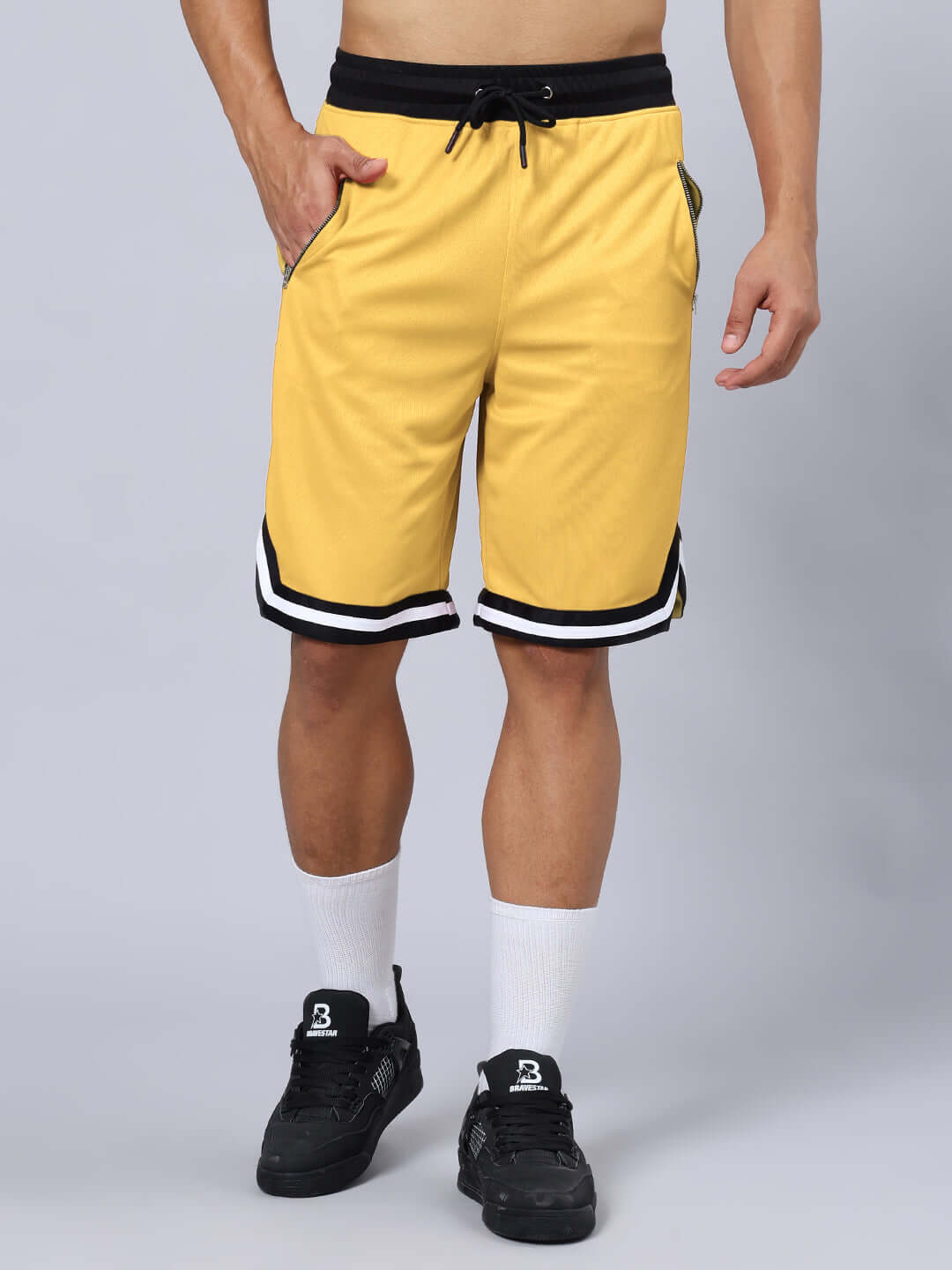 KETTLEBELL SKULL PRINTED GYM CO-ORD SET YELLOW shorts with black sneakers and white socks