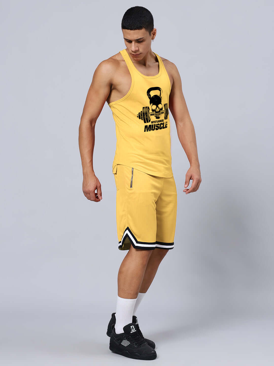 Man wearing KETTLEBELL SKULL PRINTED GYM CO-ORD SET YELLOW, featuring premium cotton t-shirt and sports polyester shorts.