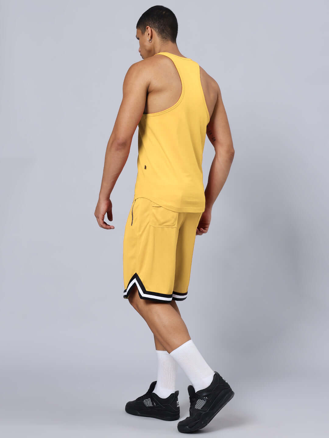 Back view of the KETTLEBELL SKULL PRINTED GYM CO-ORD SET YELLOW featuring a premium cotton tank top and sports polyester shorts.