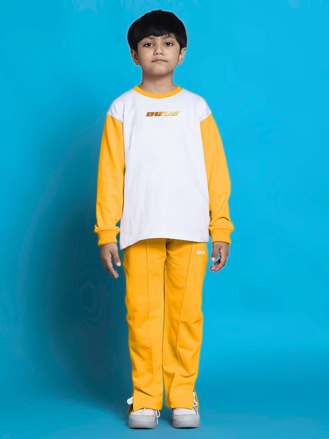 Child wearing KEVIN CO-ORD SET FOR BOYS GIRLS WHITE-YELLOW, vibrant unisex outfit for casual outings.