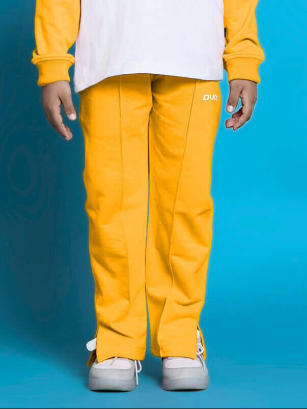 Yellow KEVIN jogger for boys & girls by DUDS, custom fit available, shown on model with vibrant background.