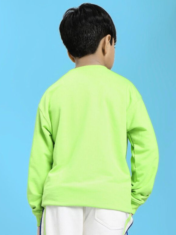 Child wearing MINI ROBOTICS SWEATSHIRT FOR BOYS AND GIRLS NEON GREEN, showing back view against blue background.