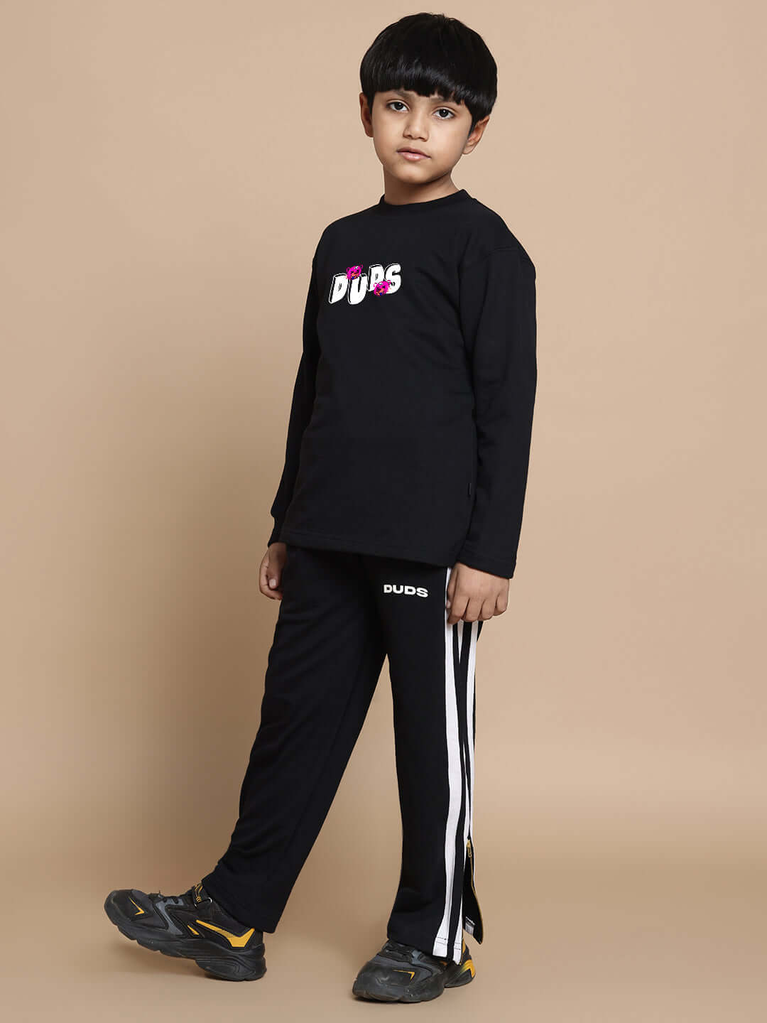 Child wearing black I'M OK Co-ord Set for boys and girls featuring elasticated joggers and a cotton top. Unisex and comfortable fit.