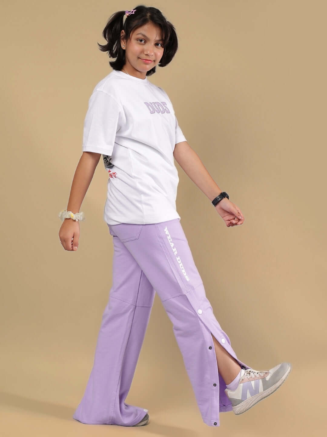 Child wearing KNIGHT RYDER CO-ORD FOR BOYS & GIRLS WHITE-LAVENDER outfit, featuring a white shirt and lavender pants. Casual and stylish look.
