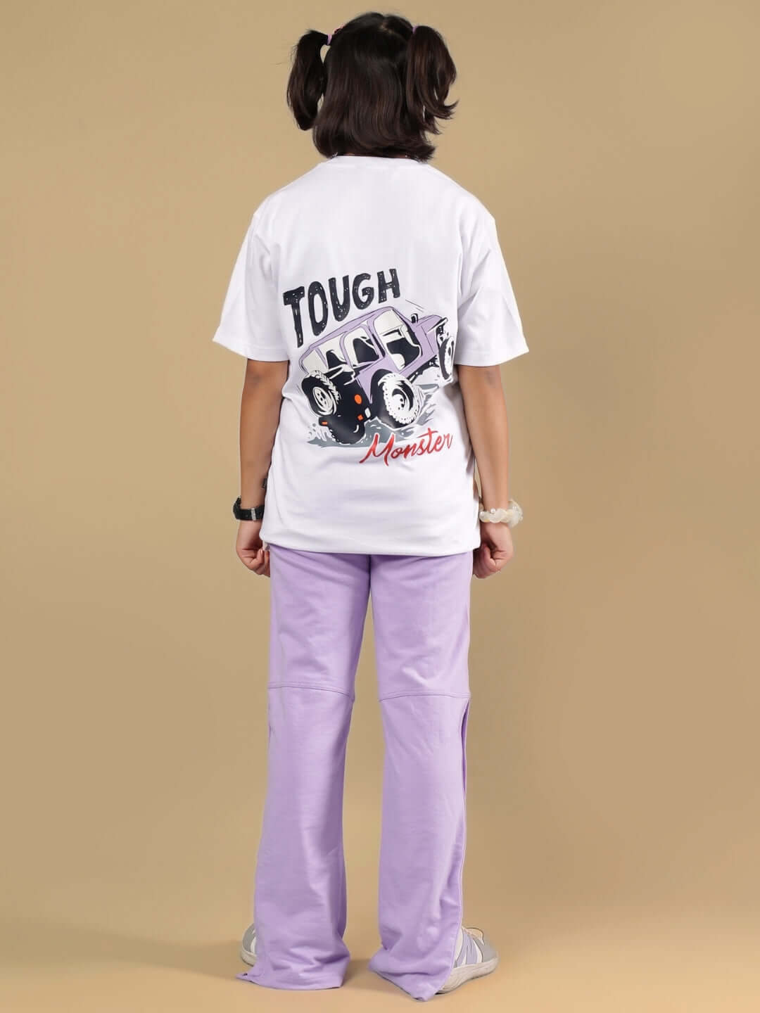 Child wearing KNIGHT RYDER CO-ORD FOR BOYS & GIRLS WHITE-LAVENDER outfit from the back, featuring white t-shirt and lavender pants.