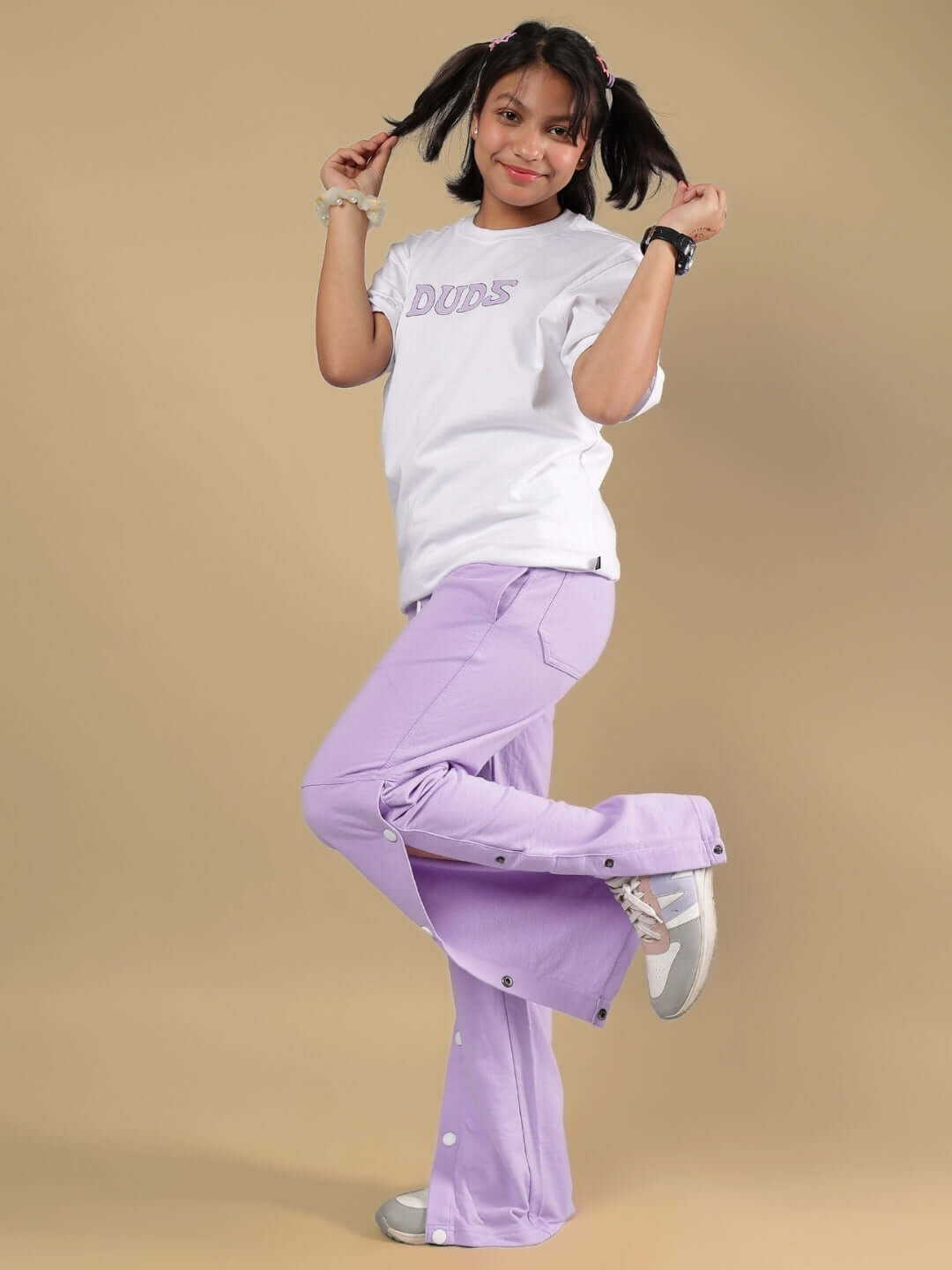 Child wearing KNIGHT RYDER CO-ORD FOR BOYS & GIRLS WHITE-LAVENDER outfit, striking a playful pose.