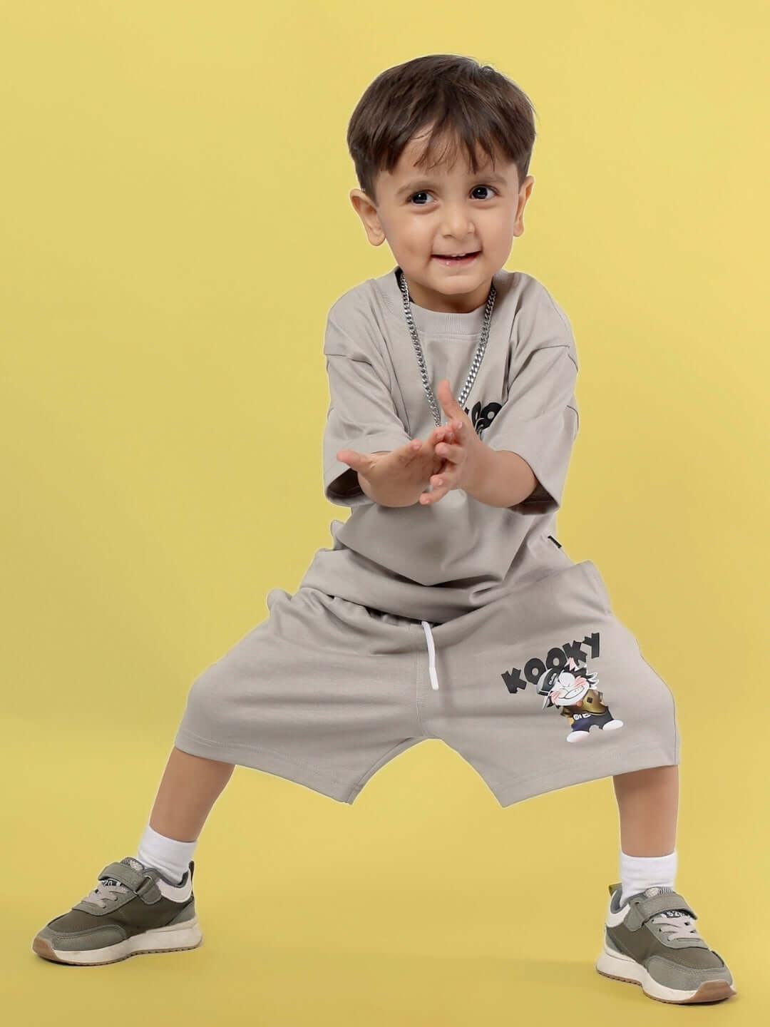 Young child wearing a grey KOOKY CO-ORD outfit, featuring playful motifs, and posing cheerfully, suitable for both boys and girls.