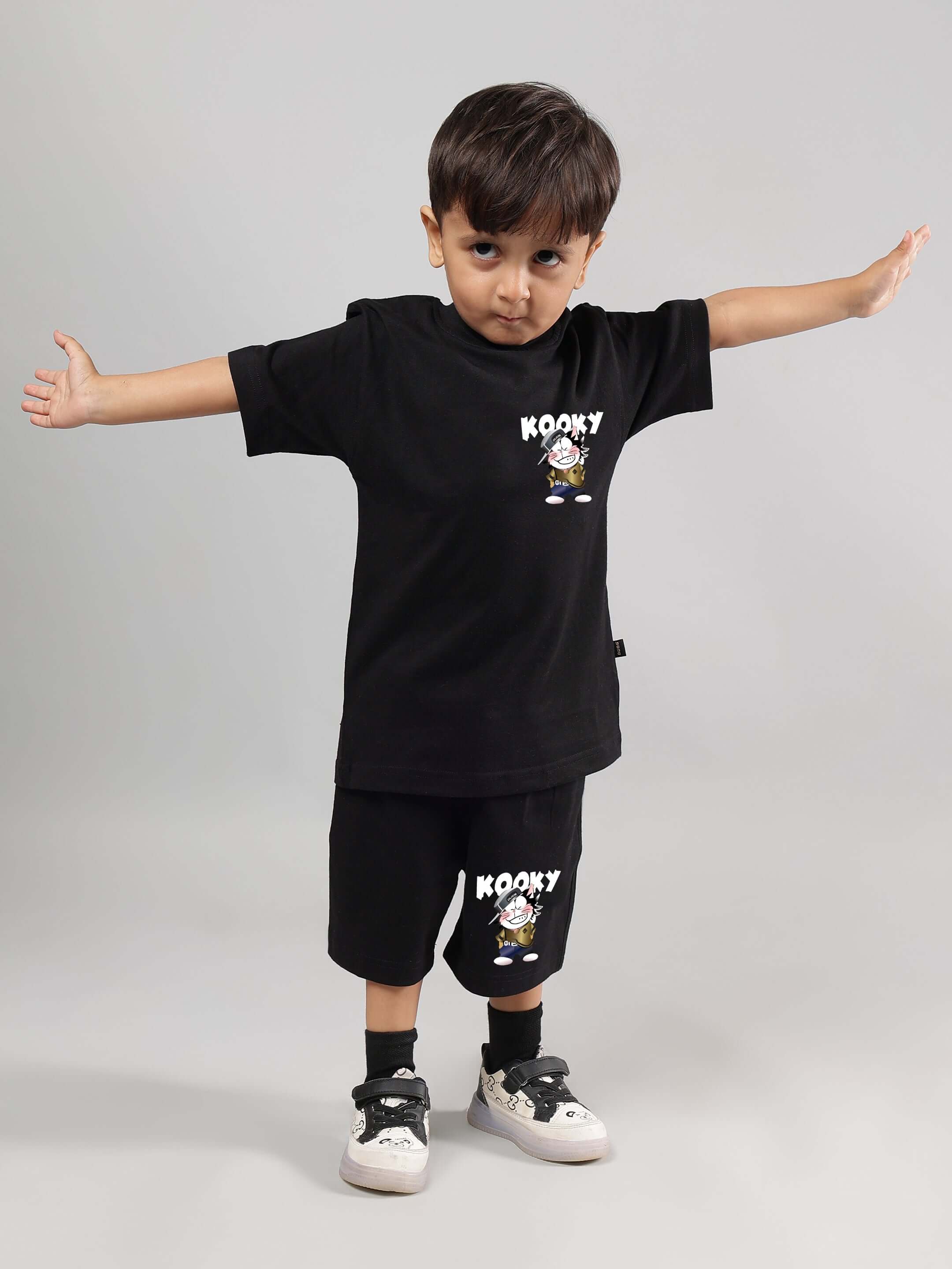 Child wearing KOOKY black co-ord set for both boys and girls, featuring trendy design and personalized sizing by DUDS.