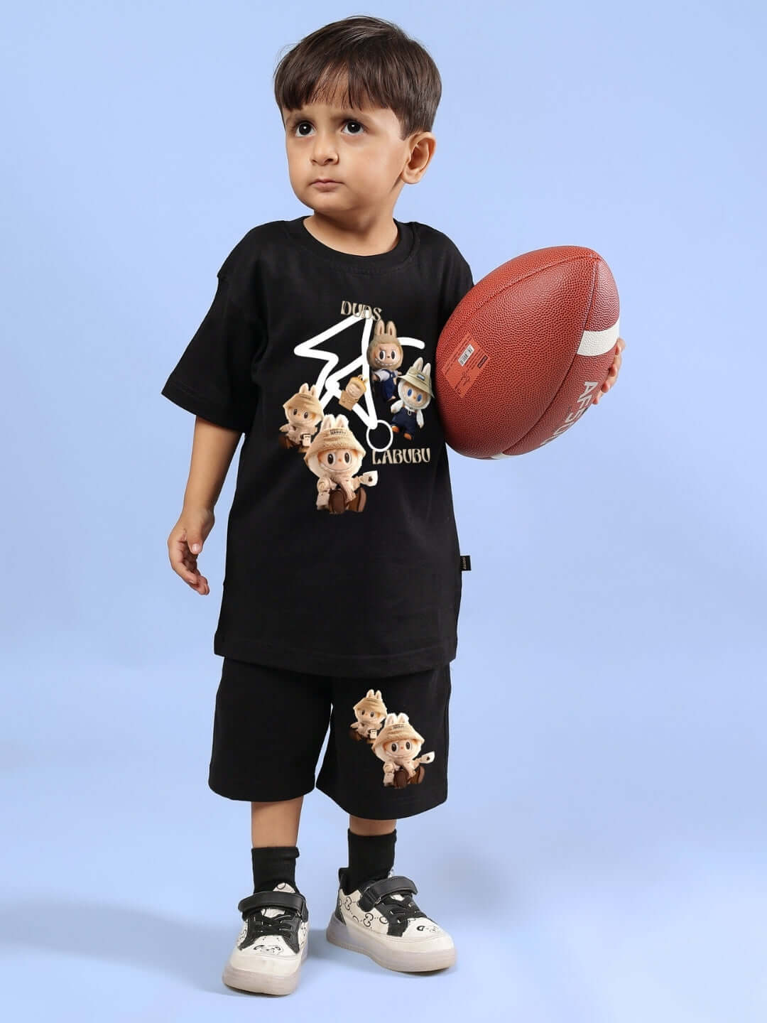 Young child in a black LABUBU GANG co-ord set holding a football, showcasing a playful design suitable for both boys and girls.