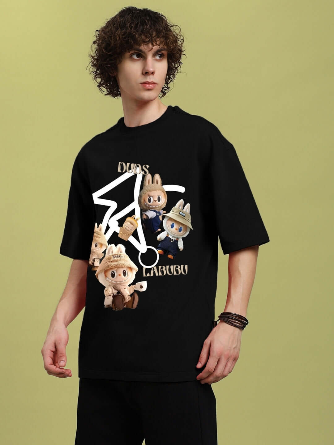 Man wearing LABUBU Gang Printed Oversized T-Shirt in black, featuring cartoon characters, made from premium cotton fabric.
