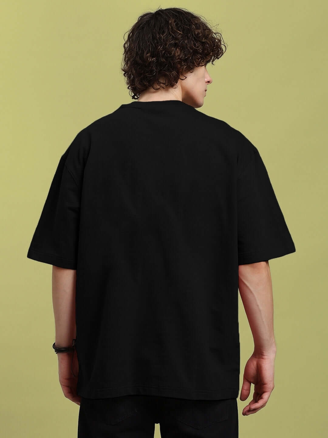 Back view of person wearing LABUBU GANG PRINTED OVERSIZED T-SHIRT BLACK, showcasing the relaxed fit and style.