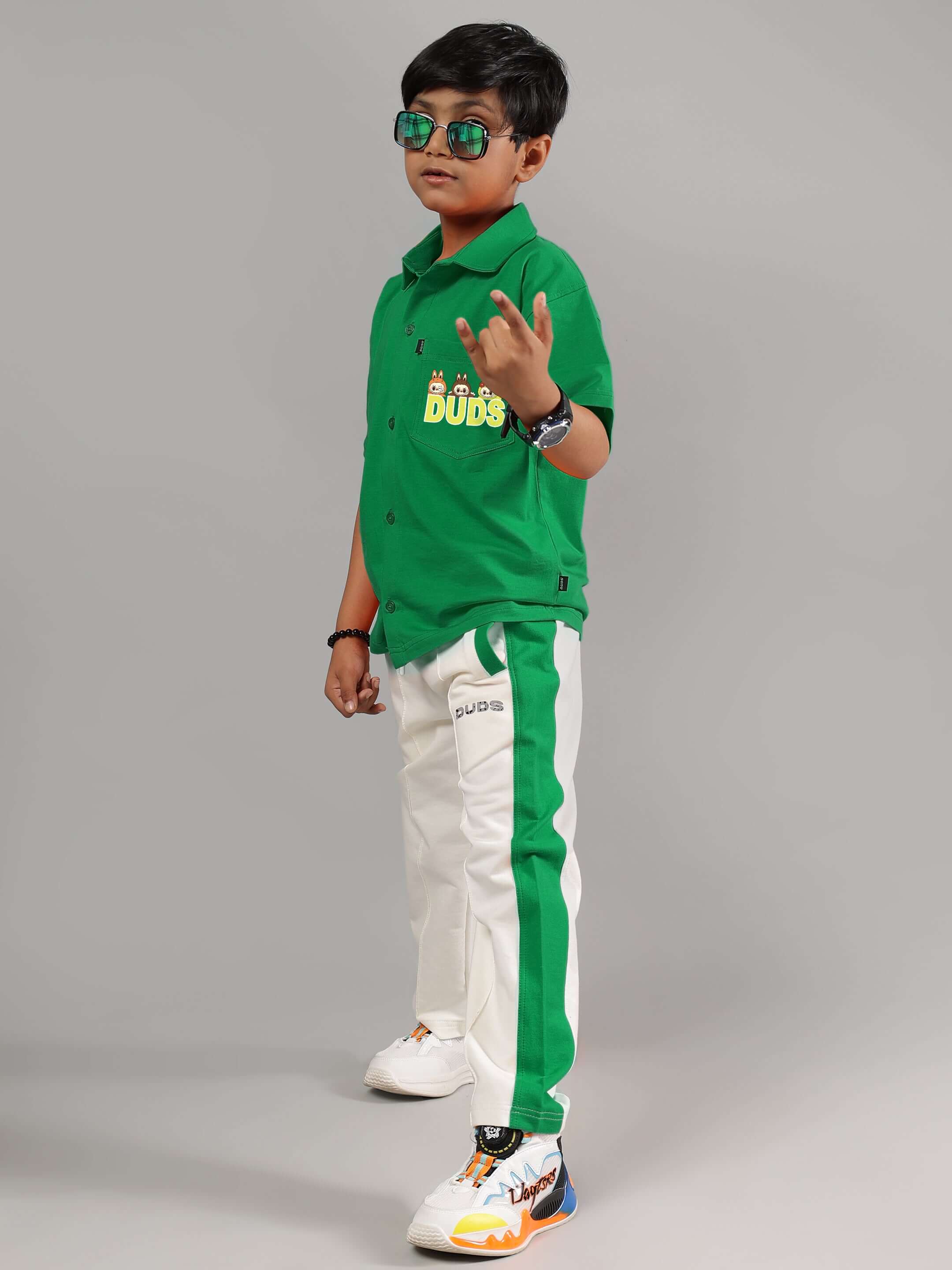 Child wearing LABUBU MYSTERY SHIRT FOR BOYS GIRLS GREEN, stylish green tee with sunglasses, displaying playful and unique fashion.
