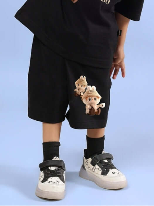 Child wearing black LABUBU GANG shorts for boys and girls with character print, showcasing stylish and comfortable fashion for kids.