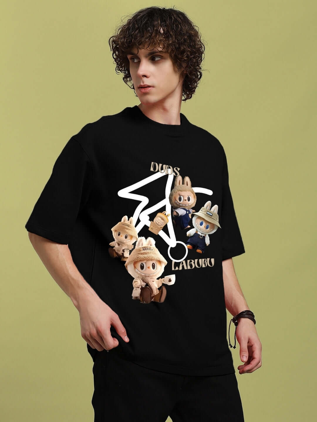 Model wearing LABUBU GANG PRINTED OVERSIZED T-SHIRT BLACK with graphic print, showcasing street-style fashion.