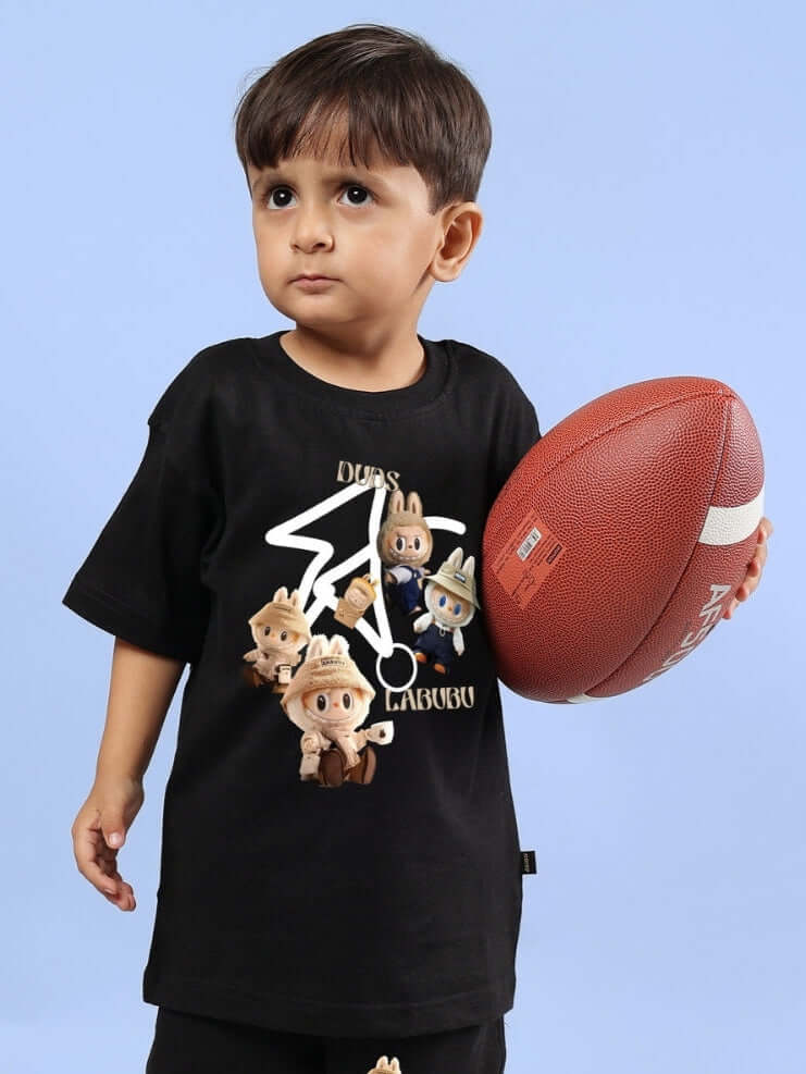 Young child wearing Labubu Gang black t-shirt holding a football, showcasing playful cartoon characters on the shirt design.