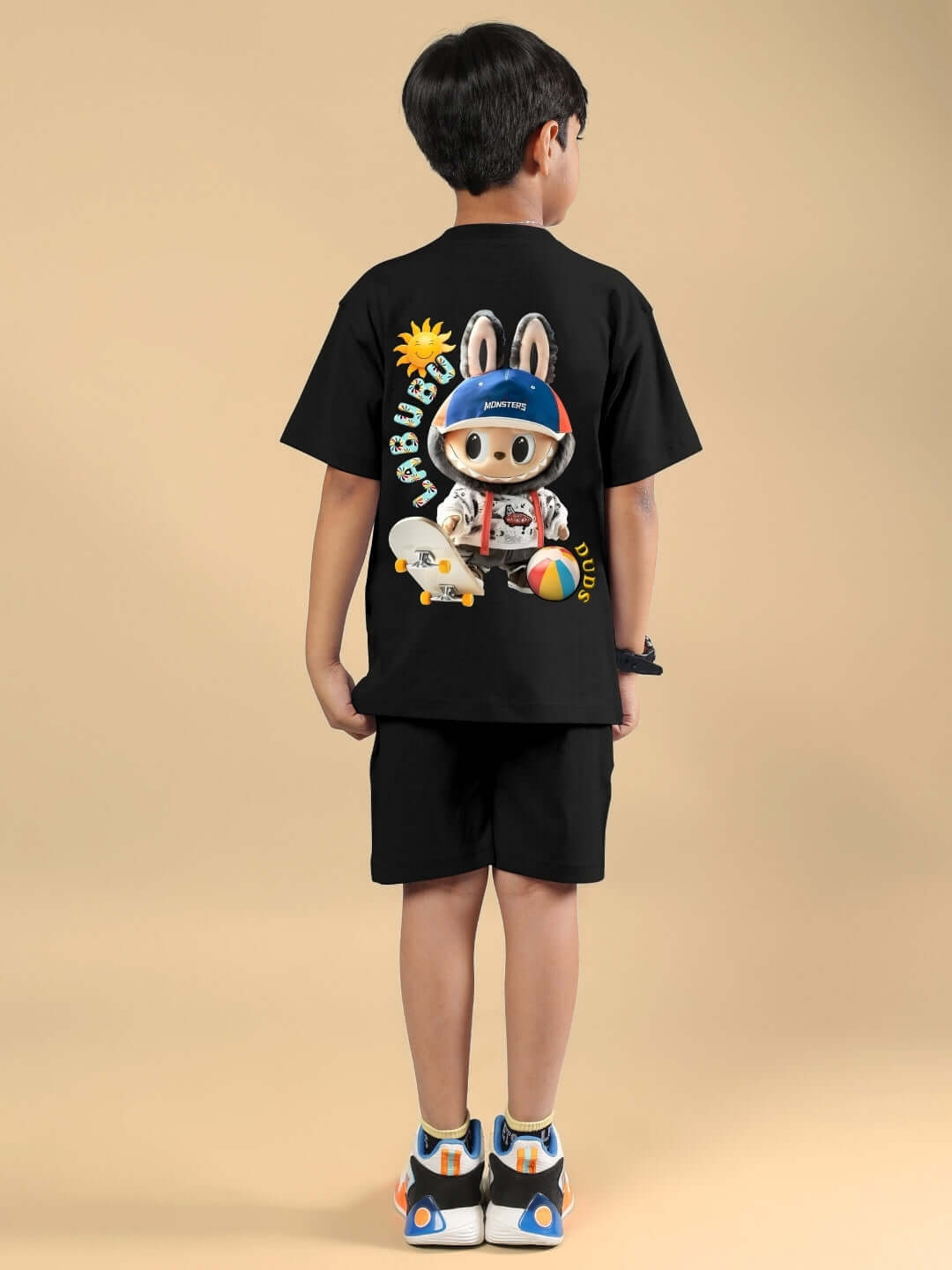 Child wearing LABUBU Monsters black co-ord set for boys & girls, featuring a playful graphic on the back. Available in custom fit for prepaid orders.