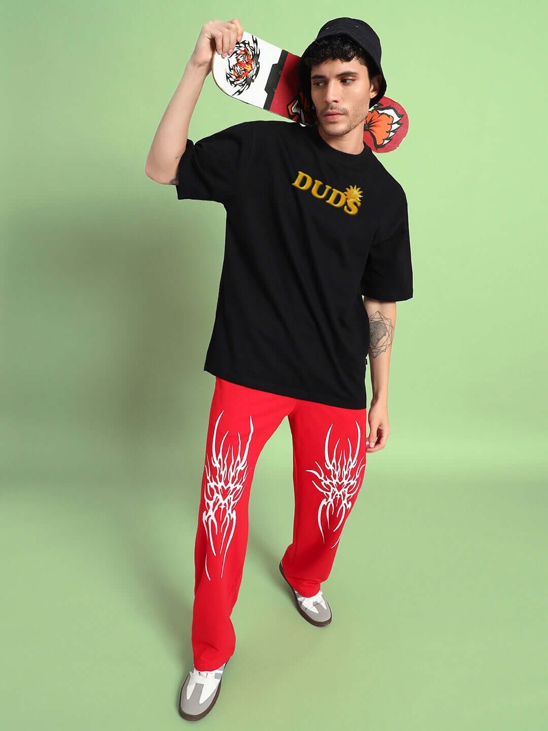 Model wearing LABUBU MONSTERS OVERSIZED T-SHIRT BLACK with bold monster graphic in playful street style setting.
