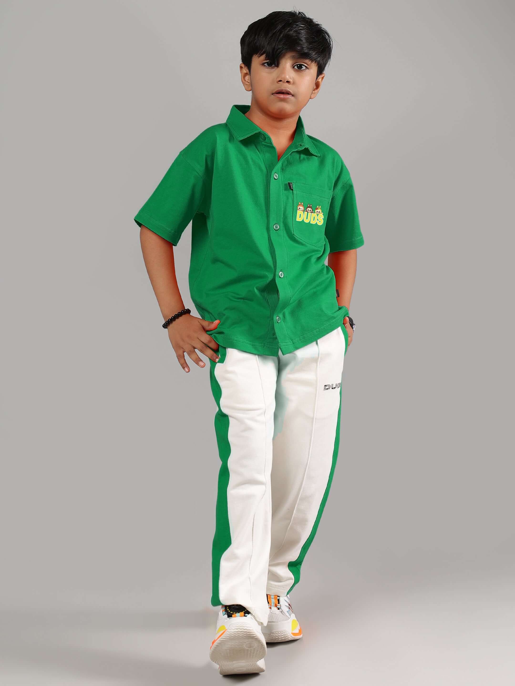 Boy wearing LABUBU Mystery Co-ord in Green-Off-White, featuring short green shirt and white-green track pants from DUDS.