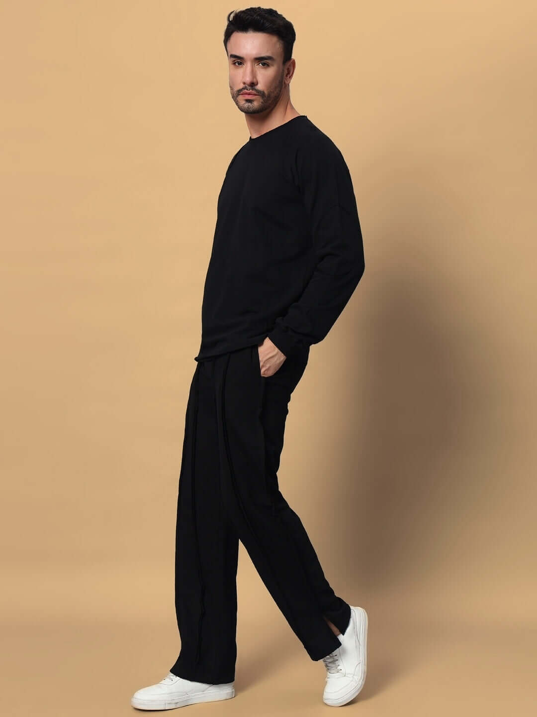 Model wearing black LAMINA oversized co-ord set, unisex relaxed fit joggers with elasticated waistband, 100% cotton, premium fabric.