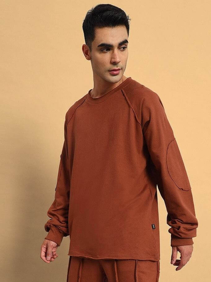 Model wearing LAMINA Oversized Brown Sweatshirt, made from premium cotton French terry lycra blend.