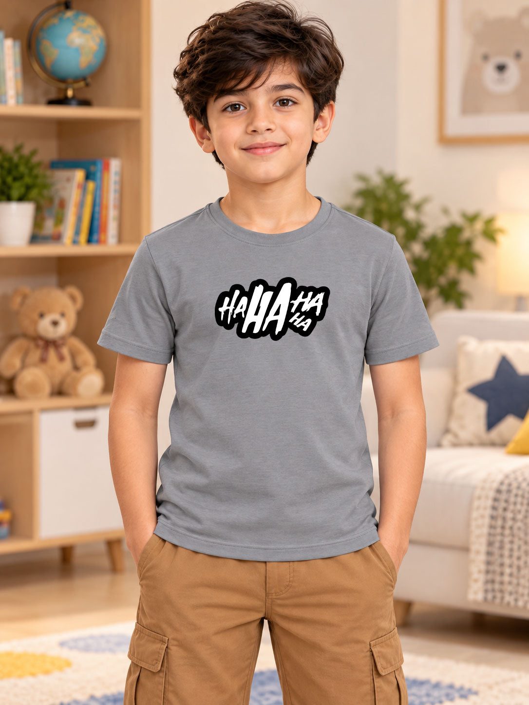 LAUGH GRAPHIC T-SHIRT FOR BOYS GIRLS GREY worn by smiling boy in cozy living room setting