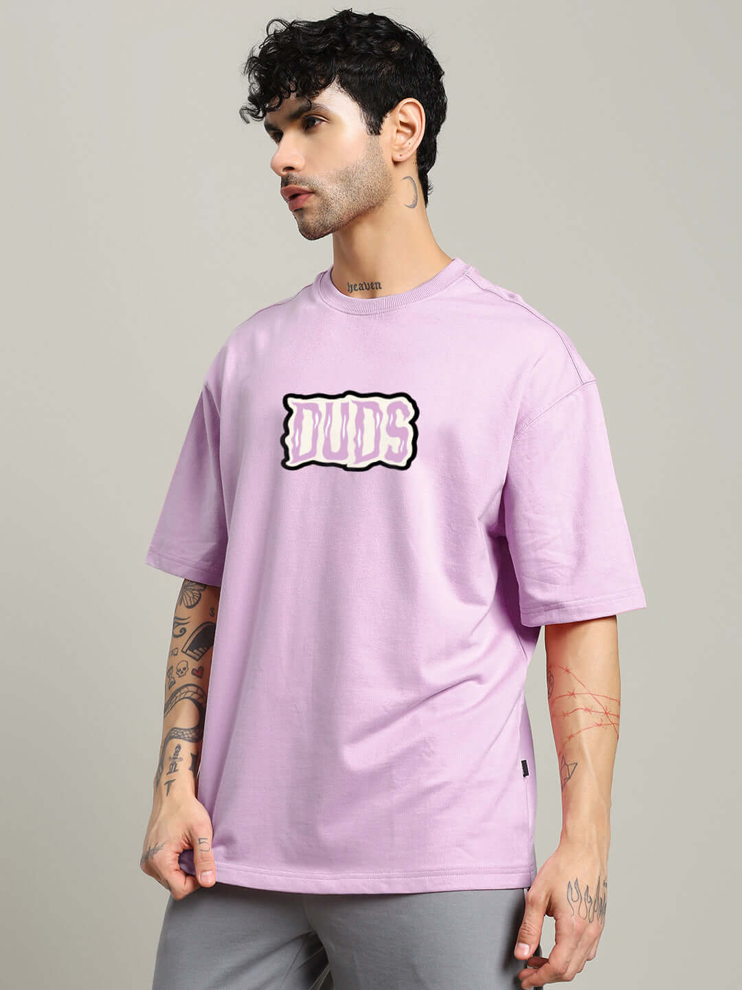 Man wearing LET'S GET SPOOKY PRINTED OVERSIZED T-SHIRT LAVENDER, streetwear fashion with bold graphic on lavender cotton tee.