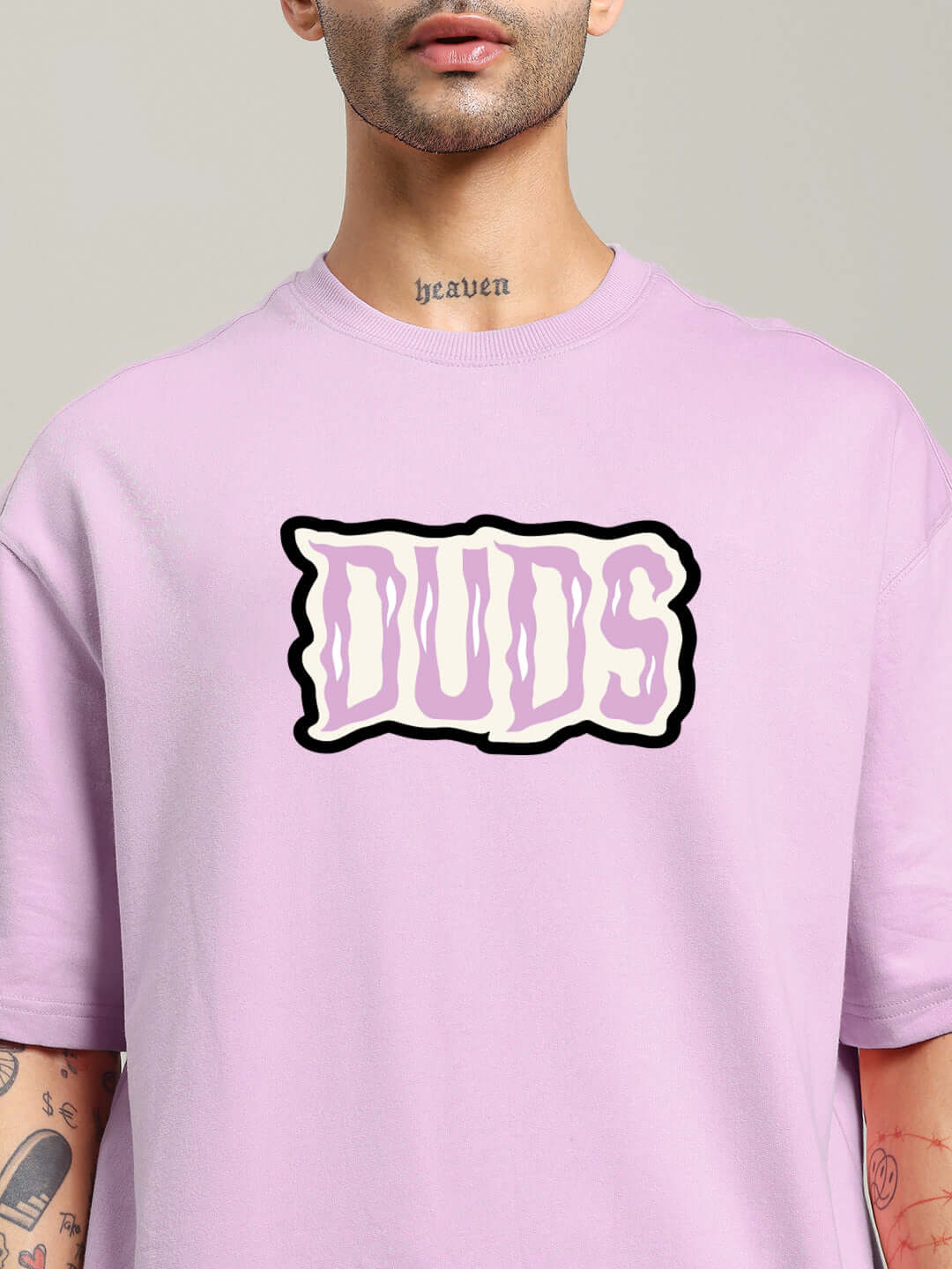 Lavender oversized T-shirt with 'DUDS' text print, premium cotton fabric. Ideal for spooky-themed attire with comfort and style.