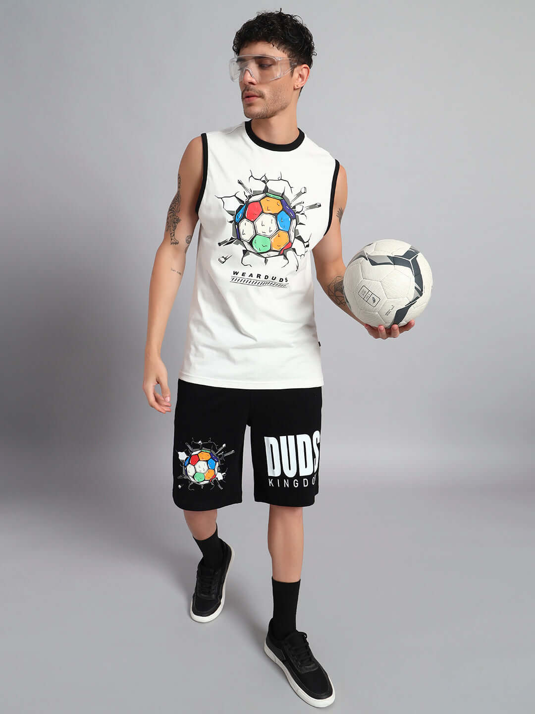 Model wearing LAZIO CO-ORD SET in off-white black with graphic design, holding a football, showcasing premium cotton fabric.