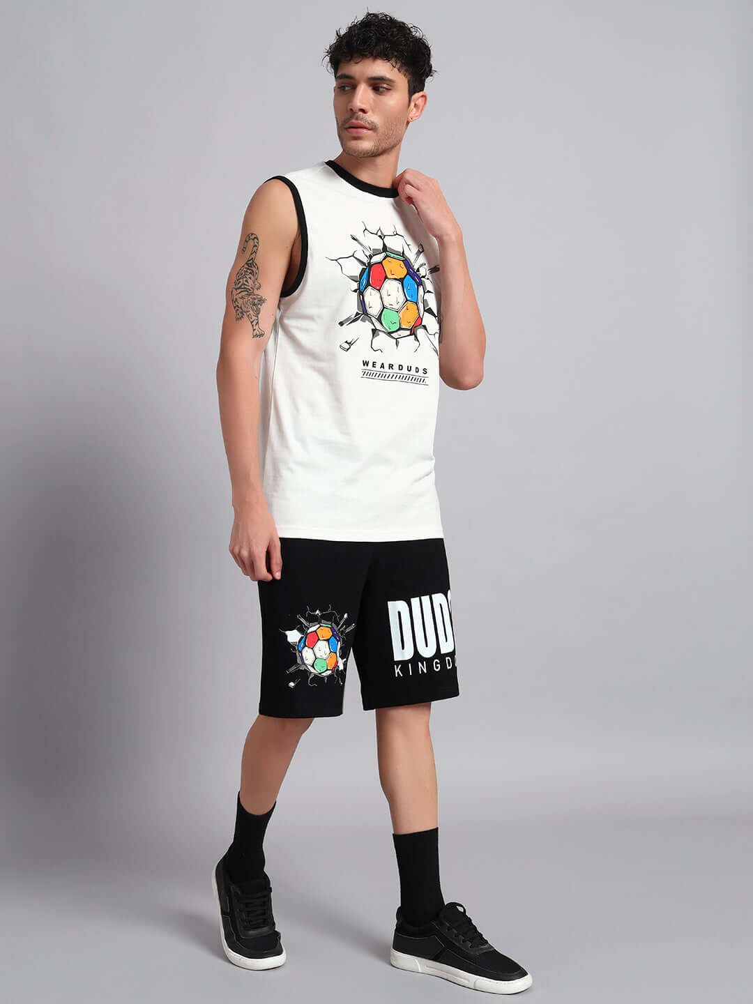 Man wearing LAZIO CO-ORD SET in off-white and black, featuring graphic design and lettering, made from premium cotton French terry.