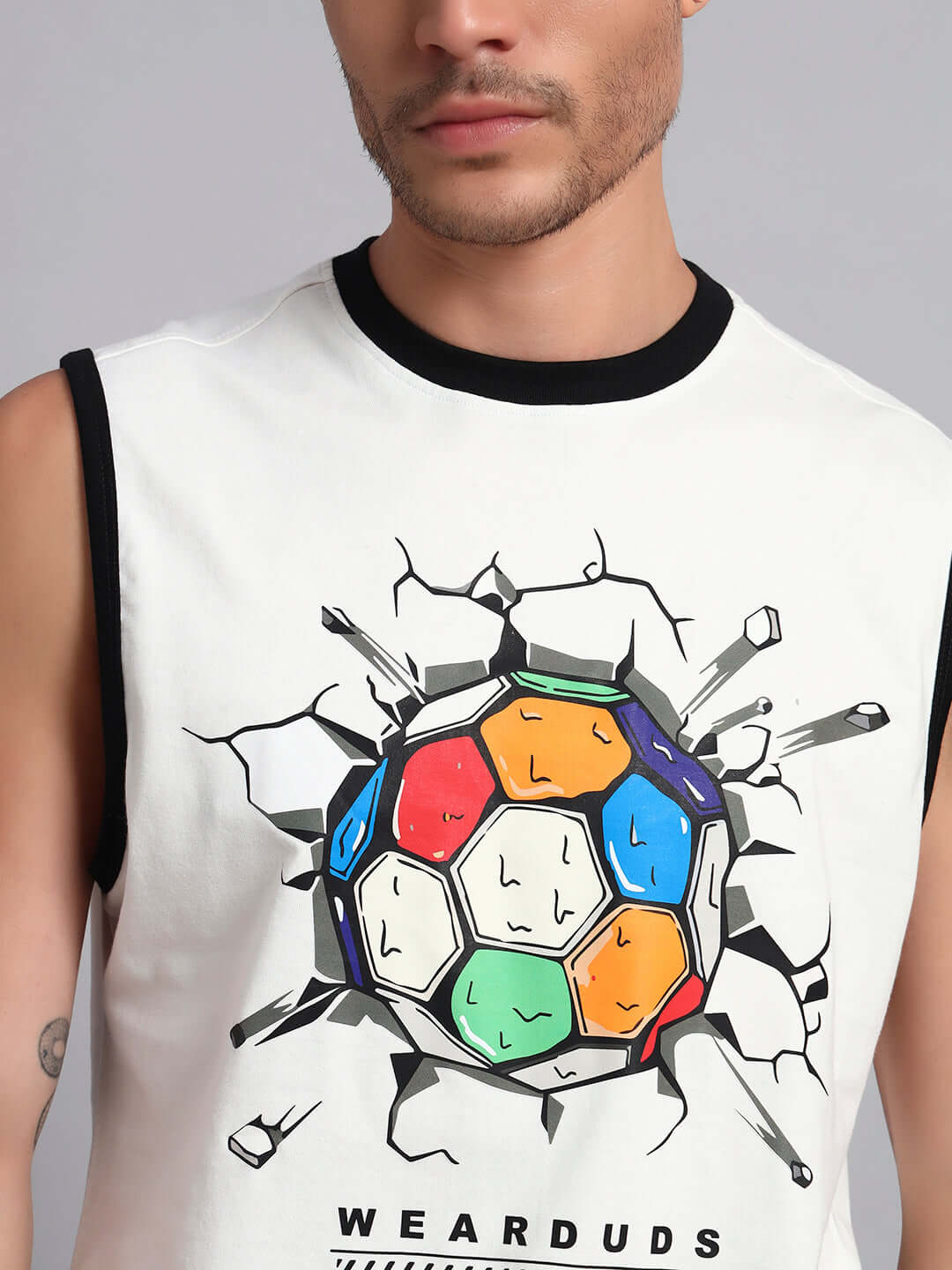 Man wearing LAZIO CO-ORD SET OFF-WHITE BLACK sleeveless top with colorful graphic