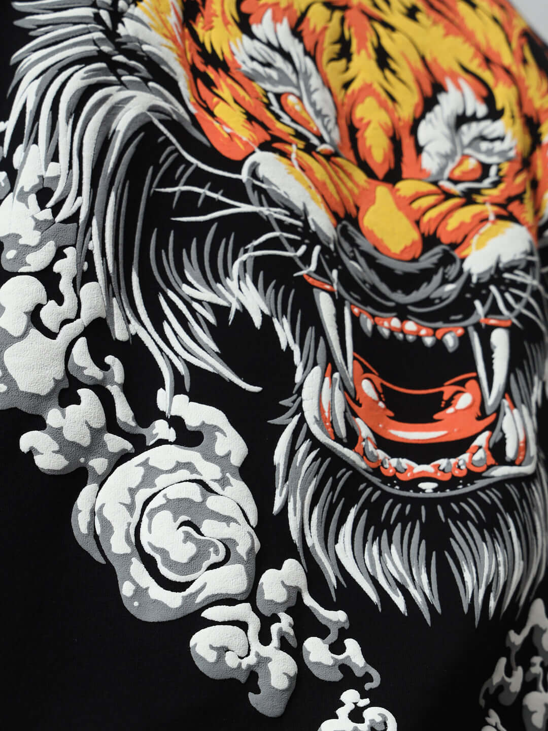 Close-up of vivid leopard puff print on black oversized T-shirt, featuring intricate detailing on premium cotton fabric.