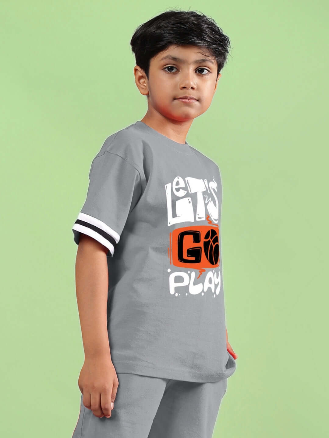 Child wearing grey 'Let's Go Play' printed t-shirt, perfect for boys and girls. Made to order by DUDS.