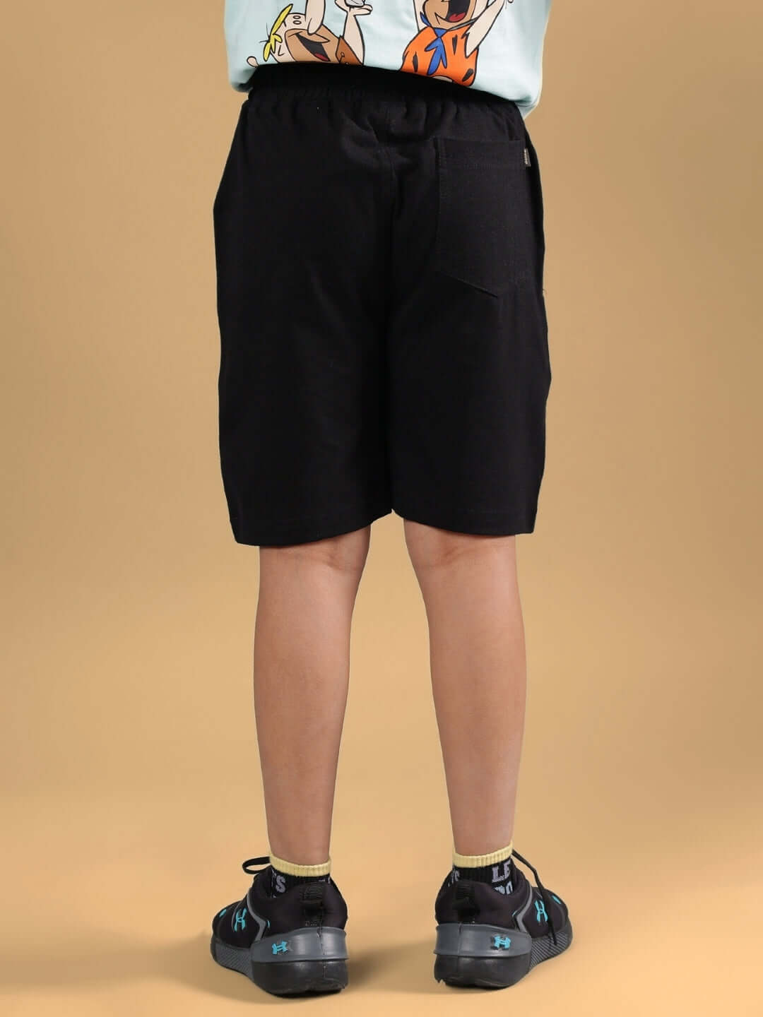 Back view of LET'S ROCK SHORTS FOR BOYS & GIRLS BLACK, showcasing comfortable fit and stylish design.
