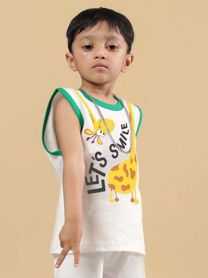 Child wearing LET'S SMILE T-SHIRT FOR BOYS AND GIRLS OFF WHITE with colorful design, standing against beige background.