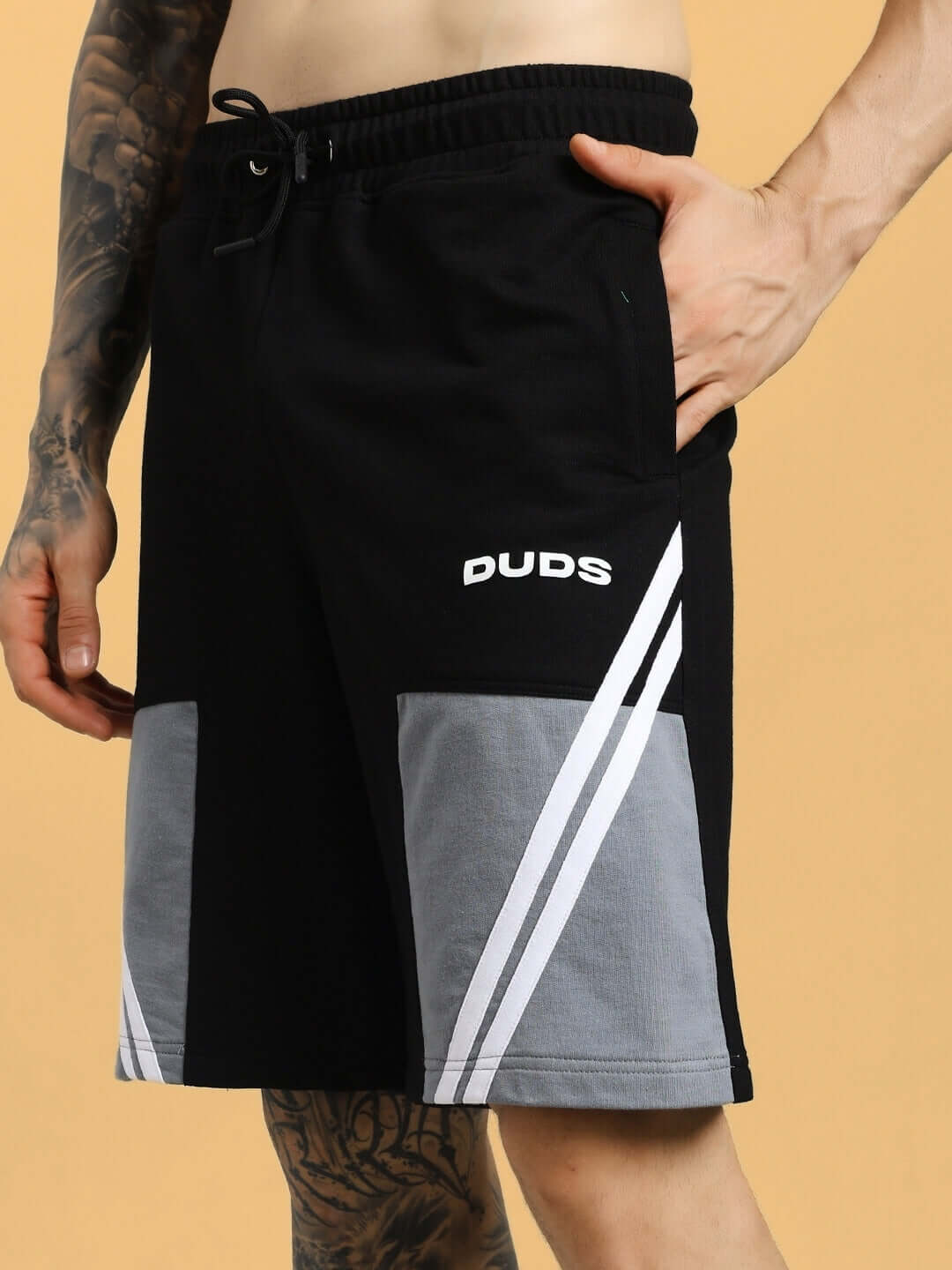 Man wearing black-grey Lewin Chino Regular Fit Shorts with logo detail, showing casual style and comfort.