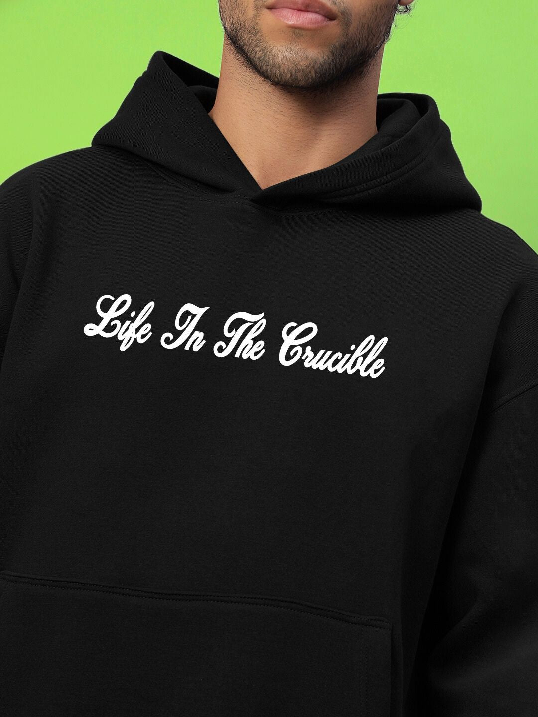 LIFE IN THE CRUCIBLE PRINTED FLEECE HOODIE BLACK worn by model, showcasing bold streetwear energy and soft premium material.