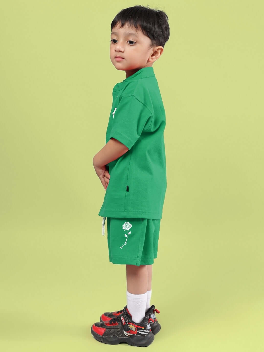 Child wearing LIMBO CO-ORD FOR BOYS & GIRLS GREEN set with shorts and shirt.
