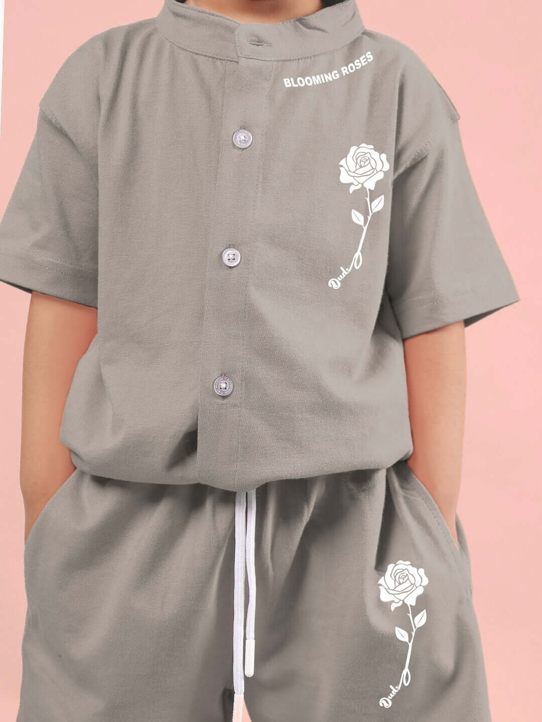 Child wearing LIMBO CO-ORD FOR BOYS & GIRLS GREY featuring a rose design on a grey shirt and shorts