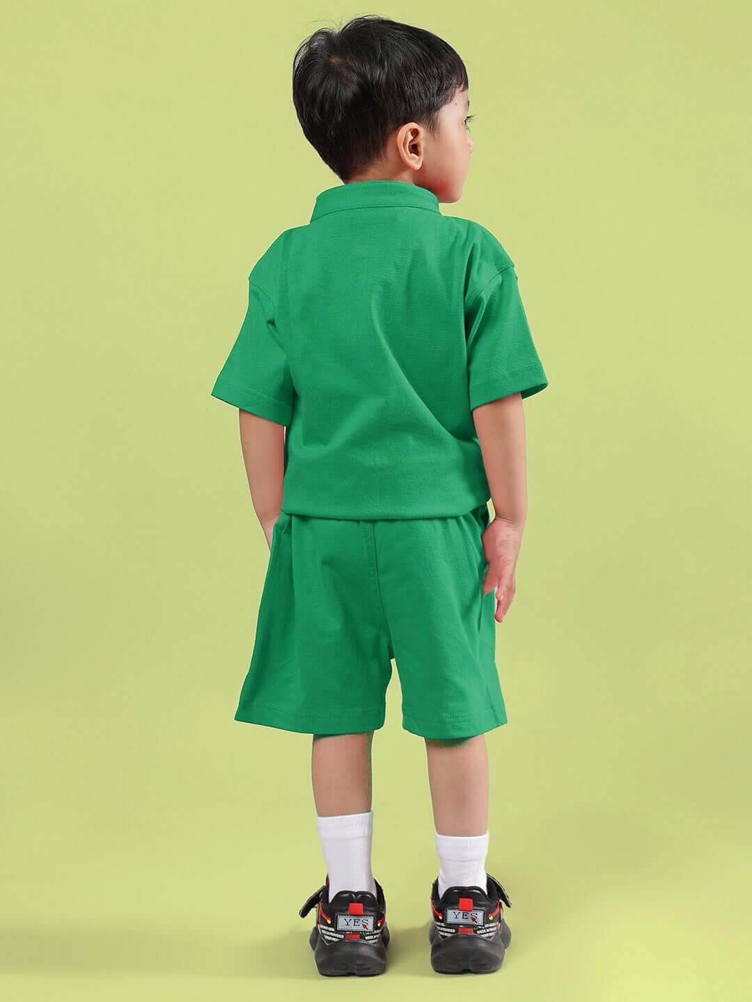 Child wearing LIMBO CO-ORD FOR BOYS & GIRLS GREEN set, featuring a green shirt and shorts, ideal for comfort and style.