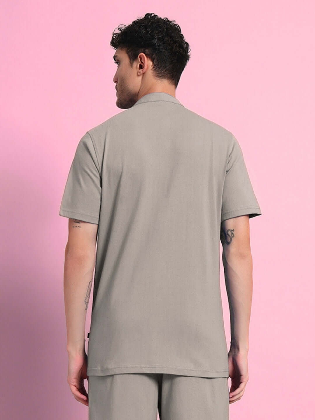 Back view of a man wearing a grey LIMBO regular fit shirt made from premium cotton French terry, emphasizing quality and comfort.